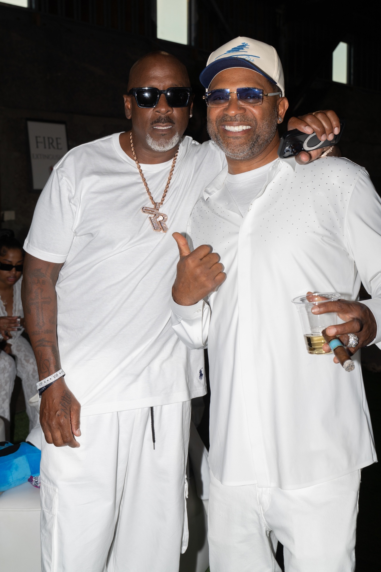 Two guests in white greeting one another at a Foundation gathering